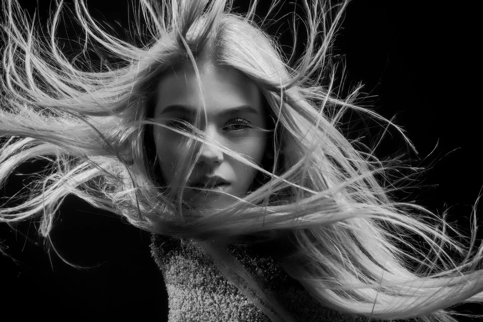 A woman with her hair being blown about